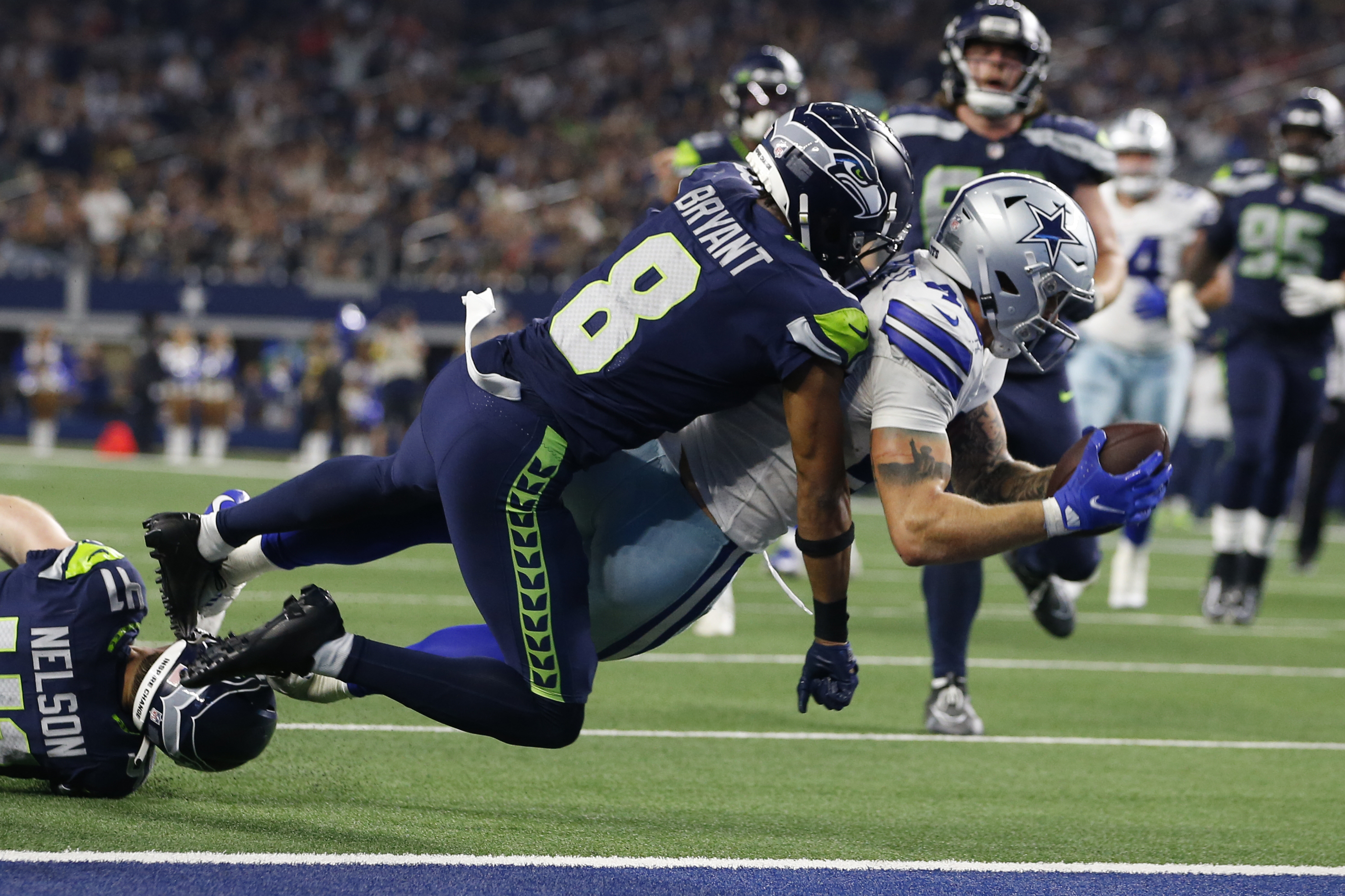Dallas Cowboys tight end Peyton Hendershot (49) scores a touchdown against Seattle Seahawks cornerback Coby Bryant (8) in the fourth quarter at AT&T Stadium.